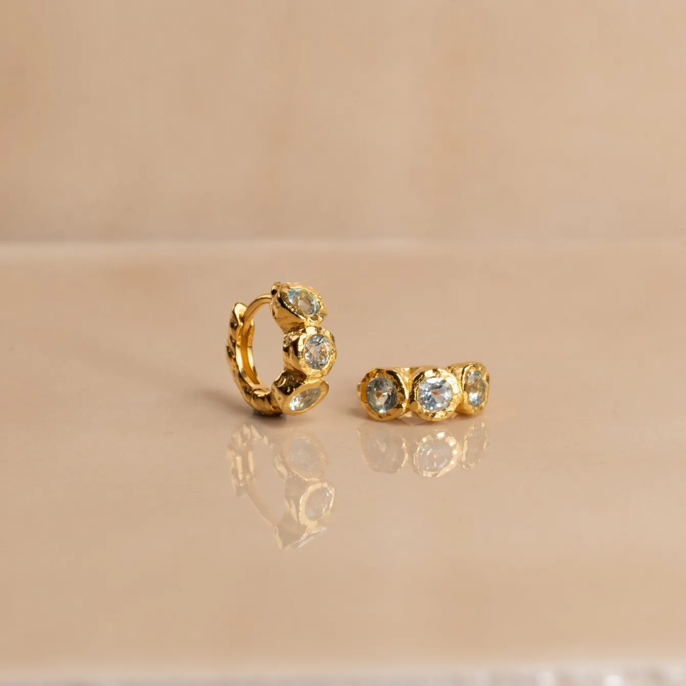 SELENE BLUE TOPAZ GOLDEN HUGGIE EARRING
