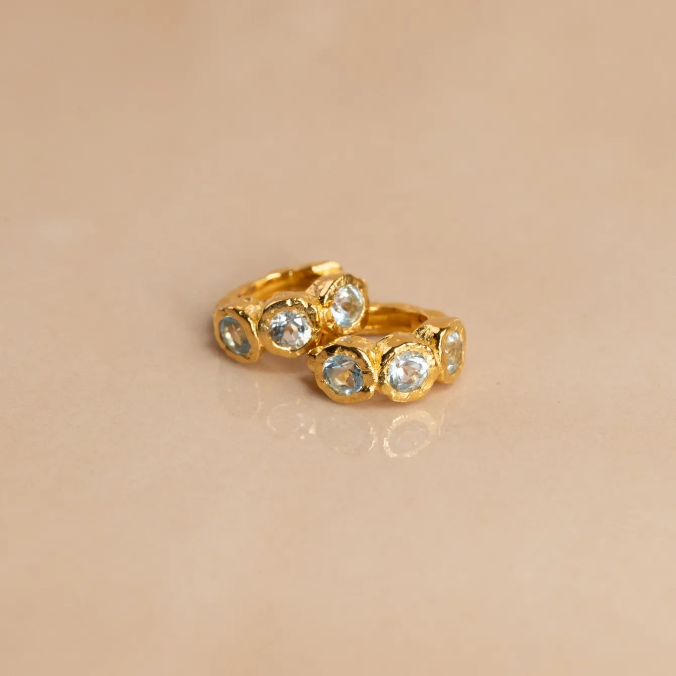 SELENE BLUE TOPAZ GOLDEN HUGGIE EARRING